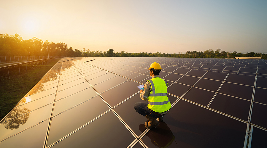 photo of man installing solar panels